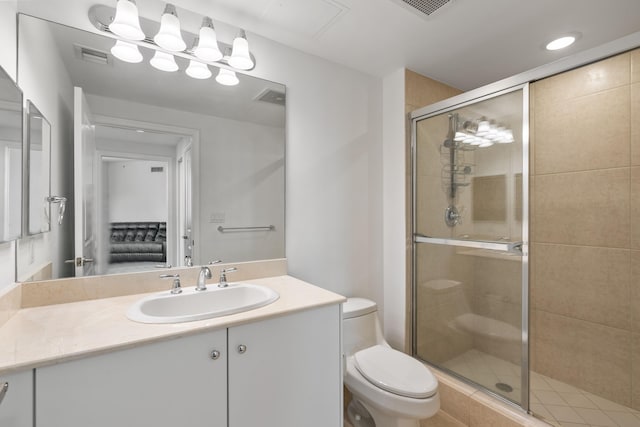 bathroom with vanity, walk in shower, and toilet