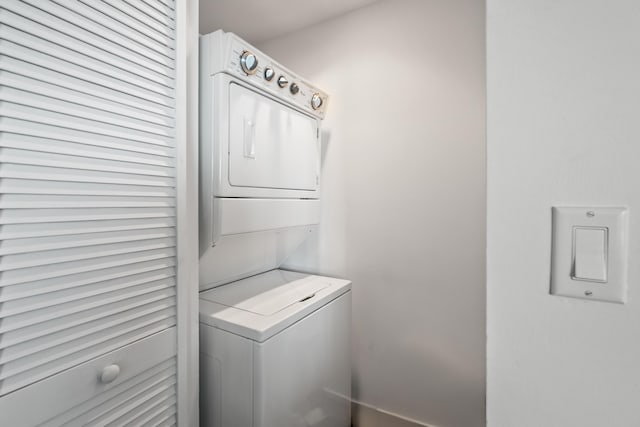 washroom with stacked washer / drying machine