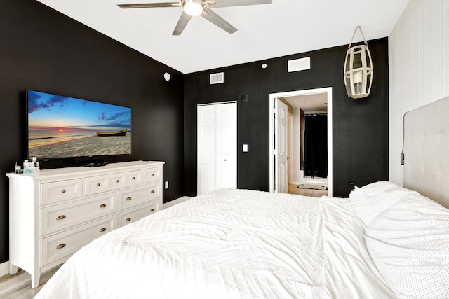 bedroom featuring ceiling fan, a closet, and light hardwood / wood-style flooring