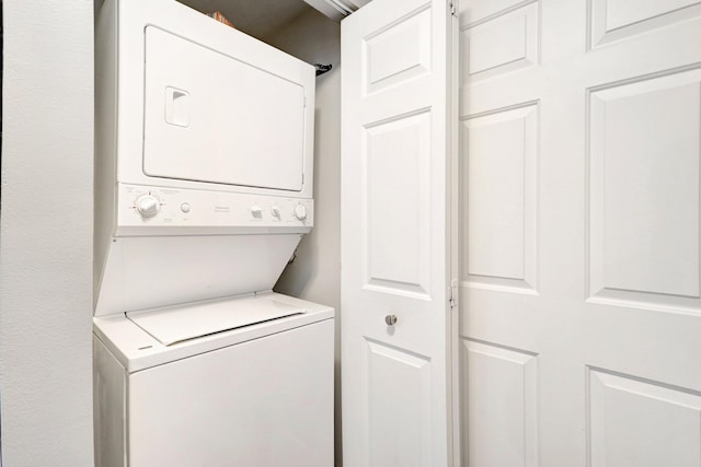 laundry area with stacked washer and dryer