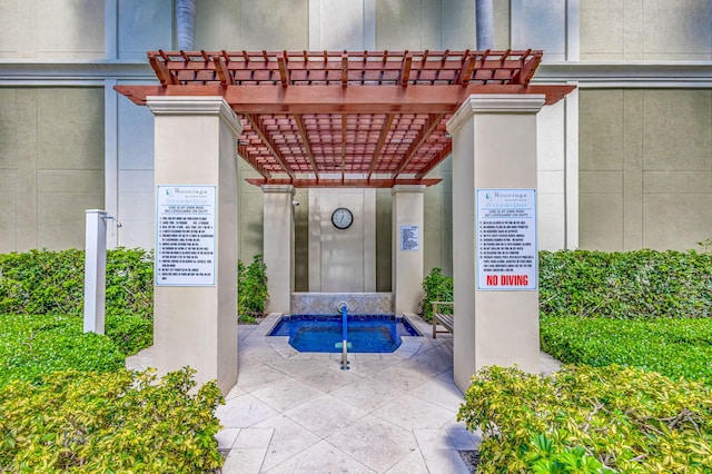 property entrance with a pergola