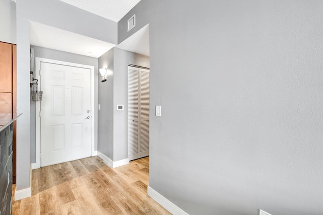 foyer with light hardwood / wood-style floors