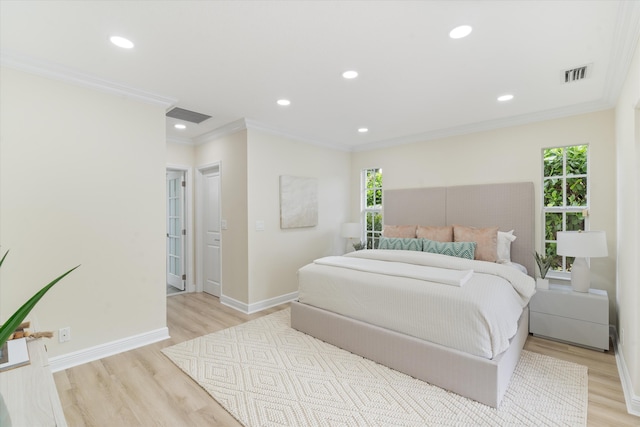 bedroom featuring light wood-type flooring and crown molding