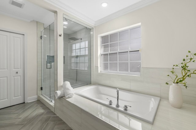 bathroom with crown molding, separate shower and tub, and tile walls