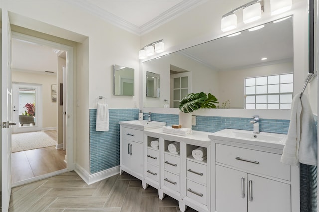 bathroom with crown molding, vanity, and backsplash