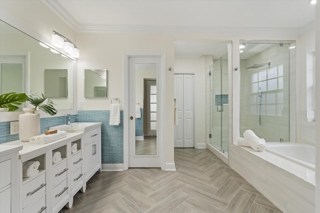 bathroom with shower with separate bathtub, parquet flooring, ornamental molding, and vanity