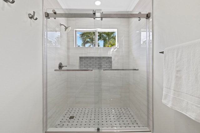 bathroom with a shower with door