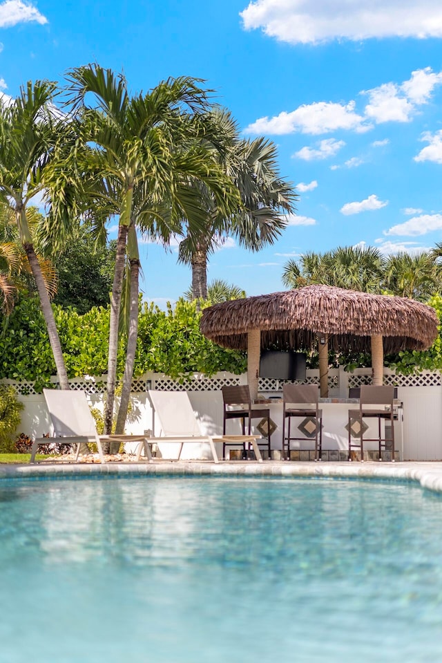 view of pool featuring a bar