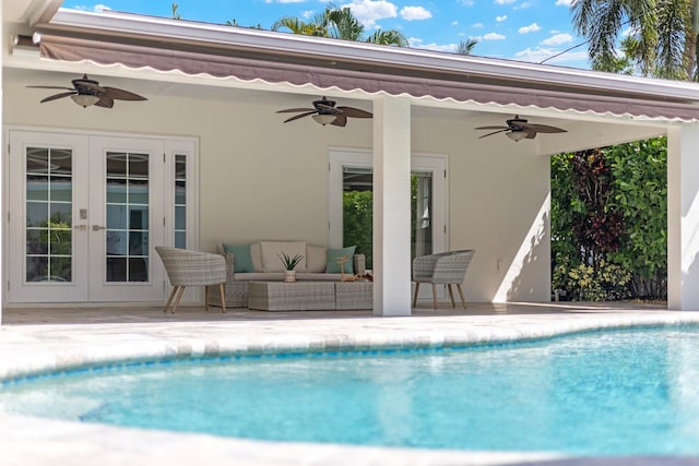 view of swimming pool featuring a patio area, ceiling fan, an outdoor hangout area, and french doors