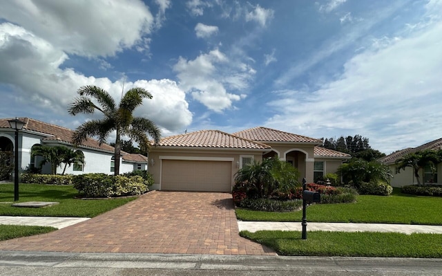 mediterranean / spanish home with a front yard and a garage