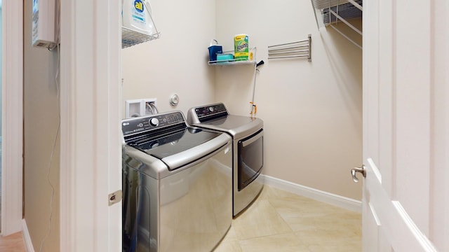 clothes washing area with separate washer and dryer