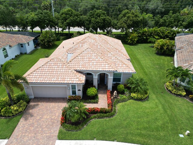 view of front of property with a front lawn and a garage