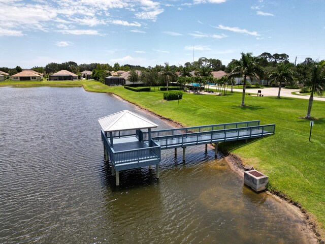 view of dock featuring a water view, a gazebo, and a yard