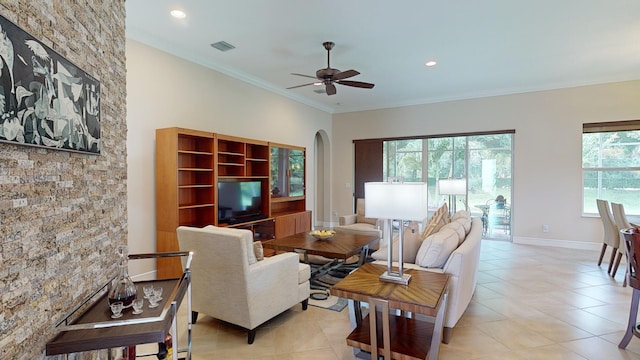 tiled living room with ceiling fan and ornamental molding