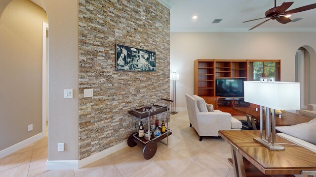 living room with ceiling fan, light tile patterned floors, and ornamental molding