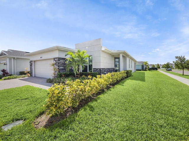 view of front facade with a garage and a front lawn