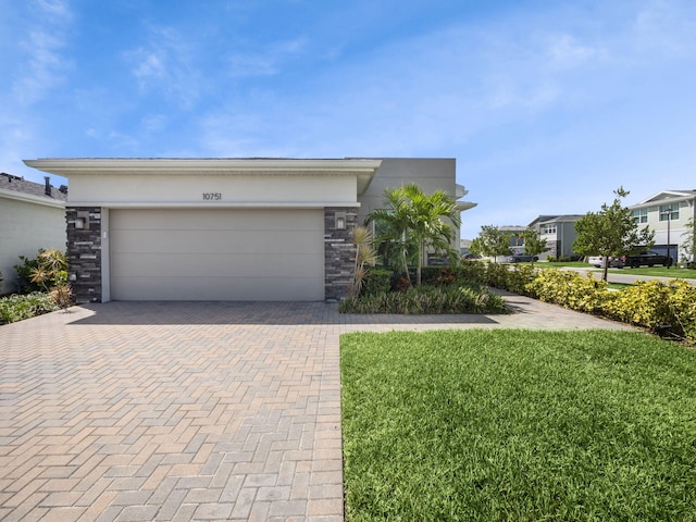 ranch-style house with a garage and a front yard