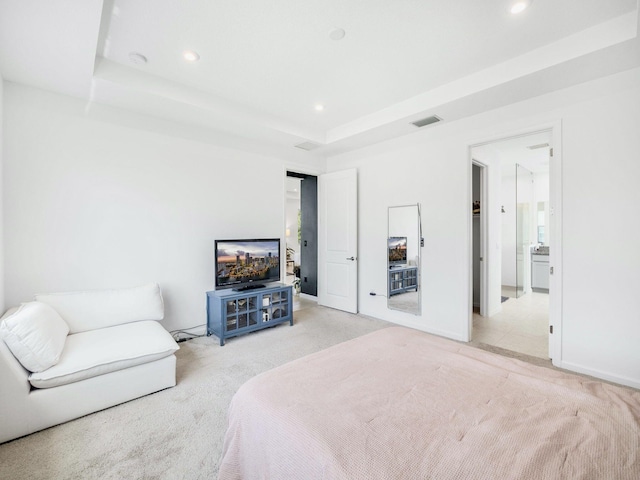 bedroom featuring a raised ceiling and light tile patterned floors