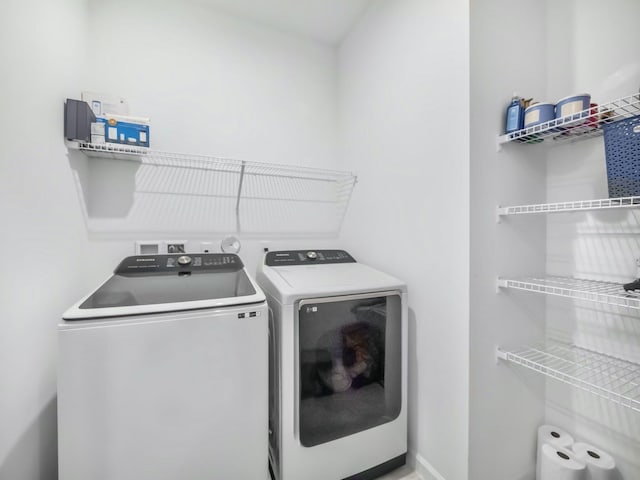 clothes washing area with independent washer and dryer