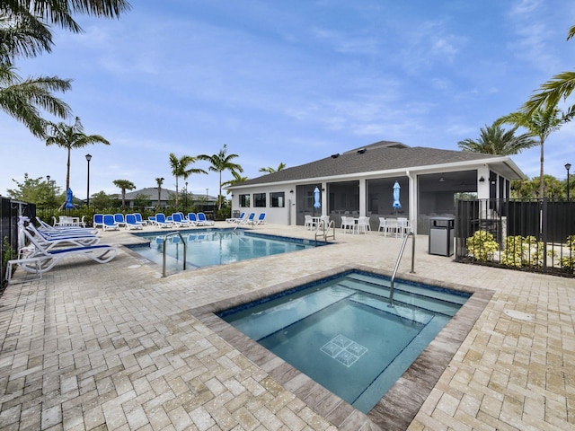 view of swimming pool with a community hot tub and a patio