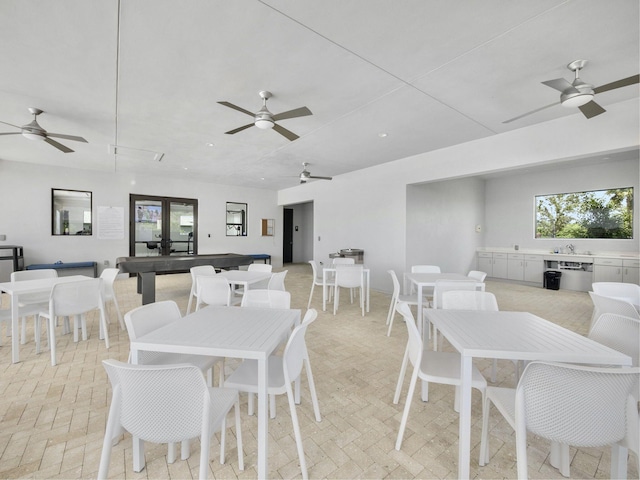 dining space with sink and ceiling fan