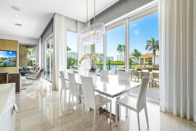 tiled dining room featuring a chandelier