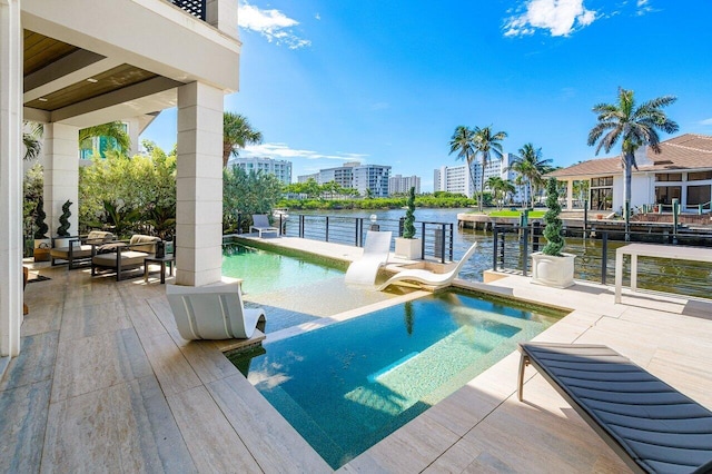 view of swimming pool with a water view and a patio