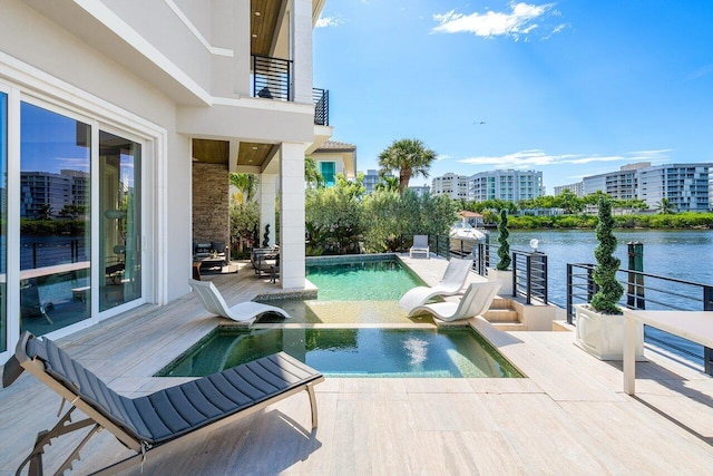 view of swimming pool featuring a water view and a patio area