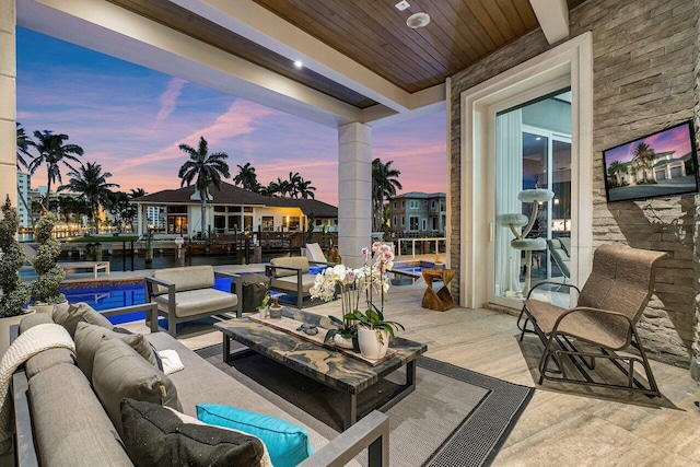 patio terrace at dusk featuring outdoor lounge area