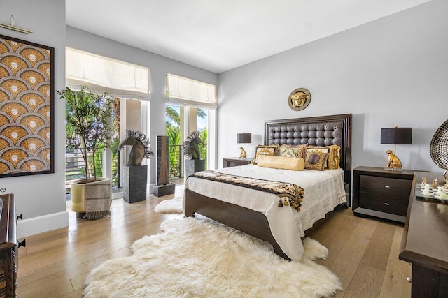 bedroom featuring light hardwood / wood-style floors and access to exterior