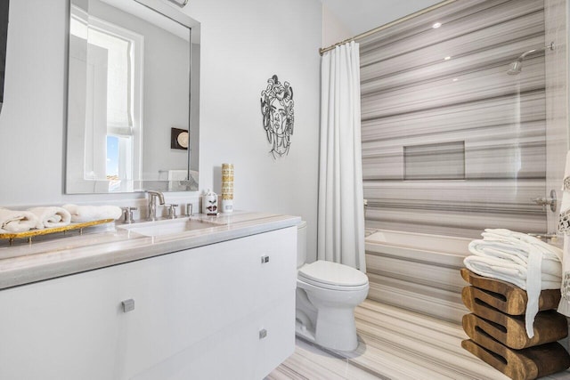 bathroom with toilet, vanity, and walk in shower