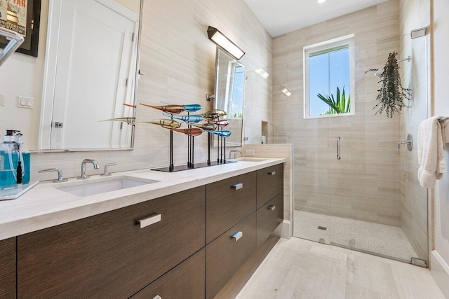 bathroom featuring vanity, tile patterned floors, an enclosed shower, and tasteful backsplash