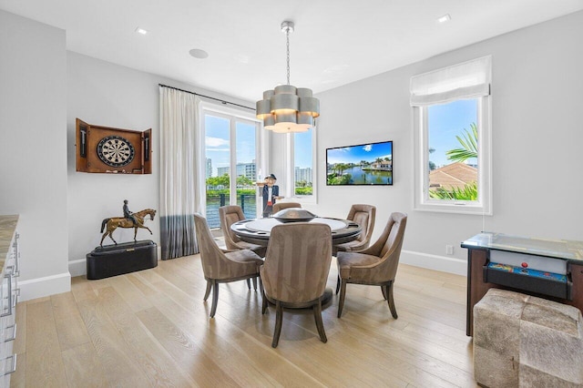 dining room featuring an inviting chandelier and light hardwood / wood-style floors