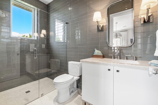 bathroom featuring tile walls, tile patterned floors, and a shower with shower door