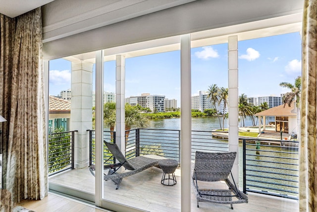 entryway featuring a water view and light hardwood / wood-style flooring