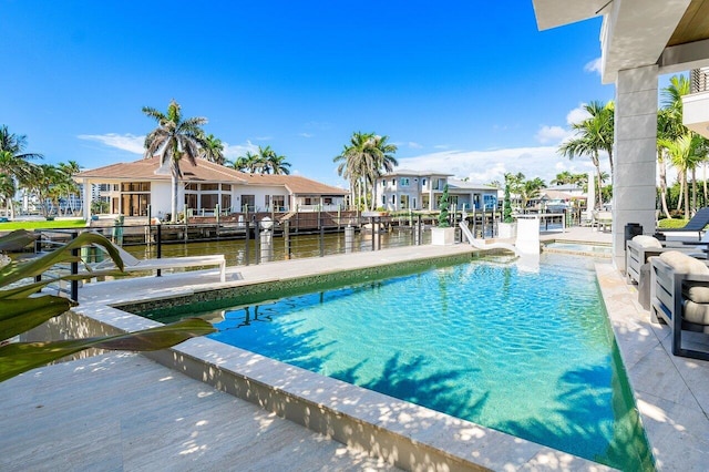 view of swimming pool featuring a water view and a boat dock