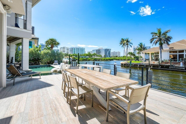 view of patio / terrace with a balcony and a water view