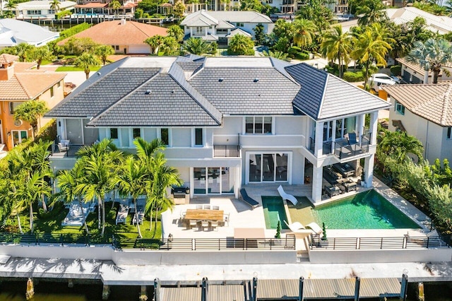 back of house featuring a patio area, outdoor lounge area, and a balcony