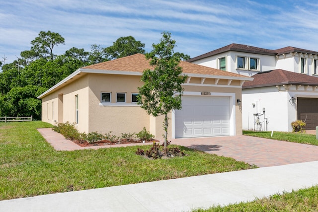 view of front of property with a front yard and a garage