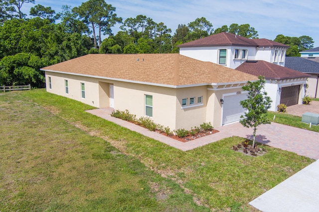 view of front of property with a garage and a front yard