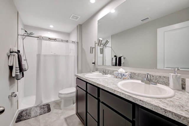 full bath featuring double vanity, visible vents, and a sink