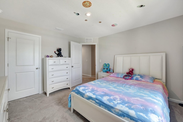 bedroom featuring light carpet, baseboards, and visible vents