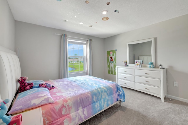 bedroom with baseboards and light colored carpet