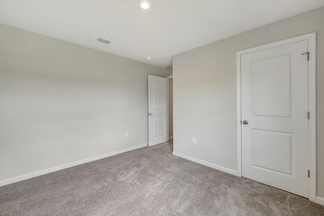 unfurnished bedroom with light carpet, baseboards, and visible vents