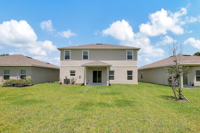 back of house with a yard and central AC unit