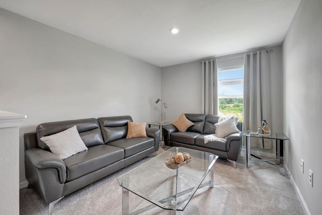 living area featuring light colored carpet and baseboards