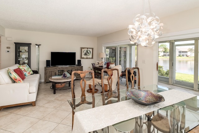 dining room featuring light tile patterned floors, a textured ceiling, and a notable chandelier