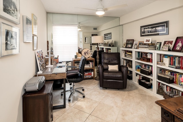 office space with ceiling fan, a textured ceiling, and light tile patterned floors