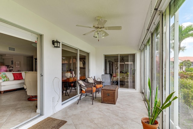 sunroom / solarium featuring ceiling fan