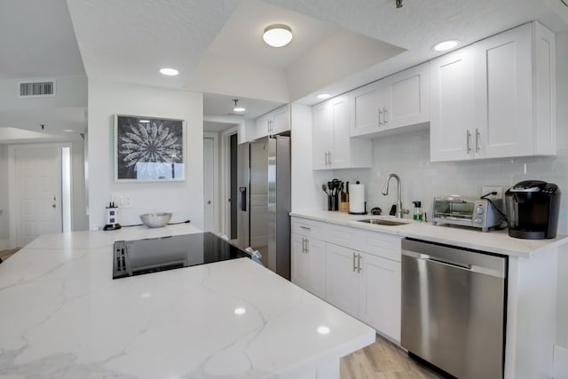 5279 Fountains Dr S Unit 602, Lake Worth, FL 33467 - kitchen with white cabinets, a toaster, visible vents, a sink, and appliances with stainless steel finishes